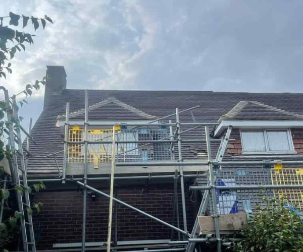 This is a photo of a roof with two dormers that is having some damaged tiles replaced. Works carried out by LPO Roofing Kempston